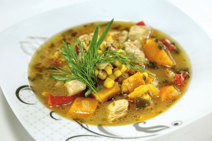 Flavorful homemade chicken soup with corn and pumpkin