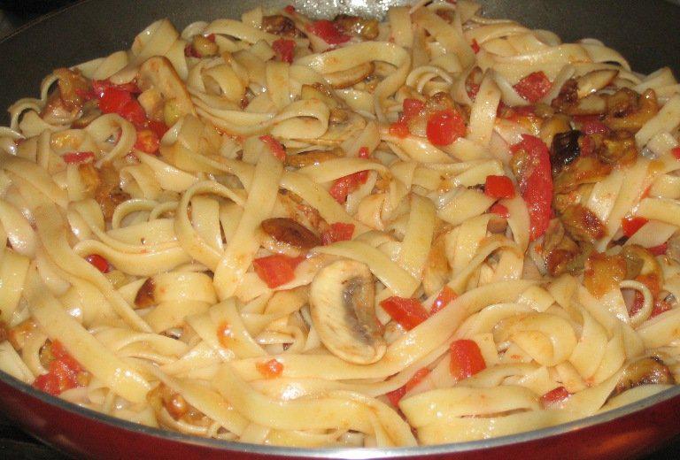 Italian Cuisine. Spicy fettuccini with eggplant and mushrooms
