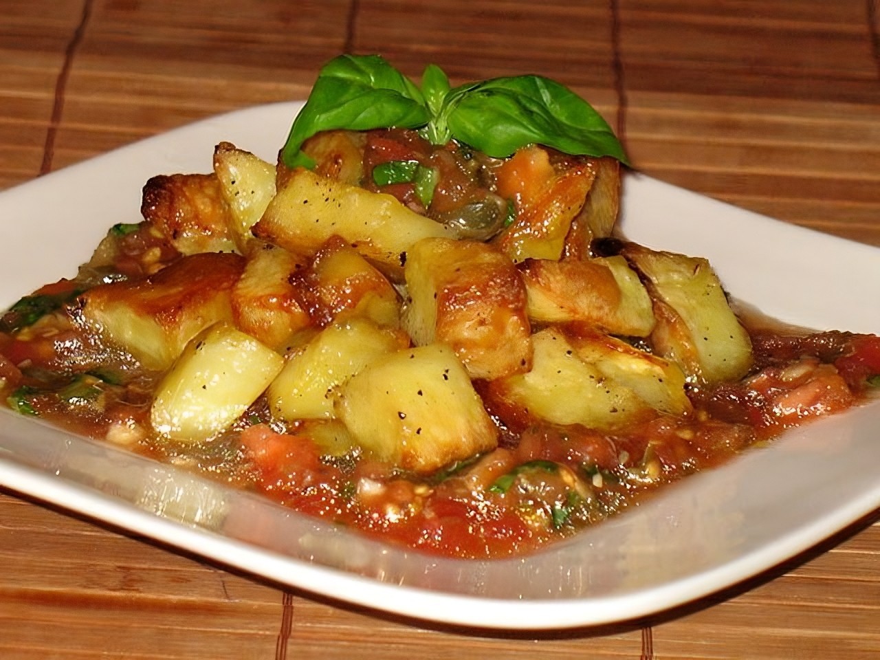 Quick side dish of baked potatoes with marinated tomatoes